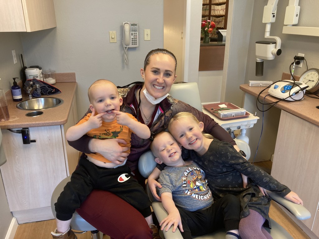 Dr. Eilise with niece and nephews in dentist office.