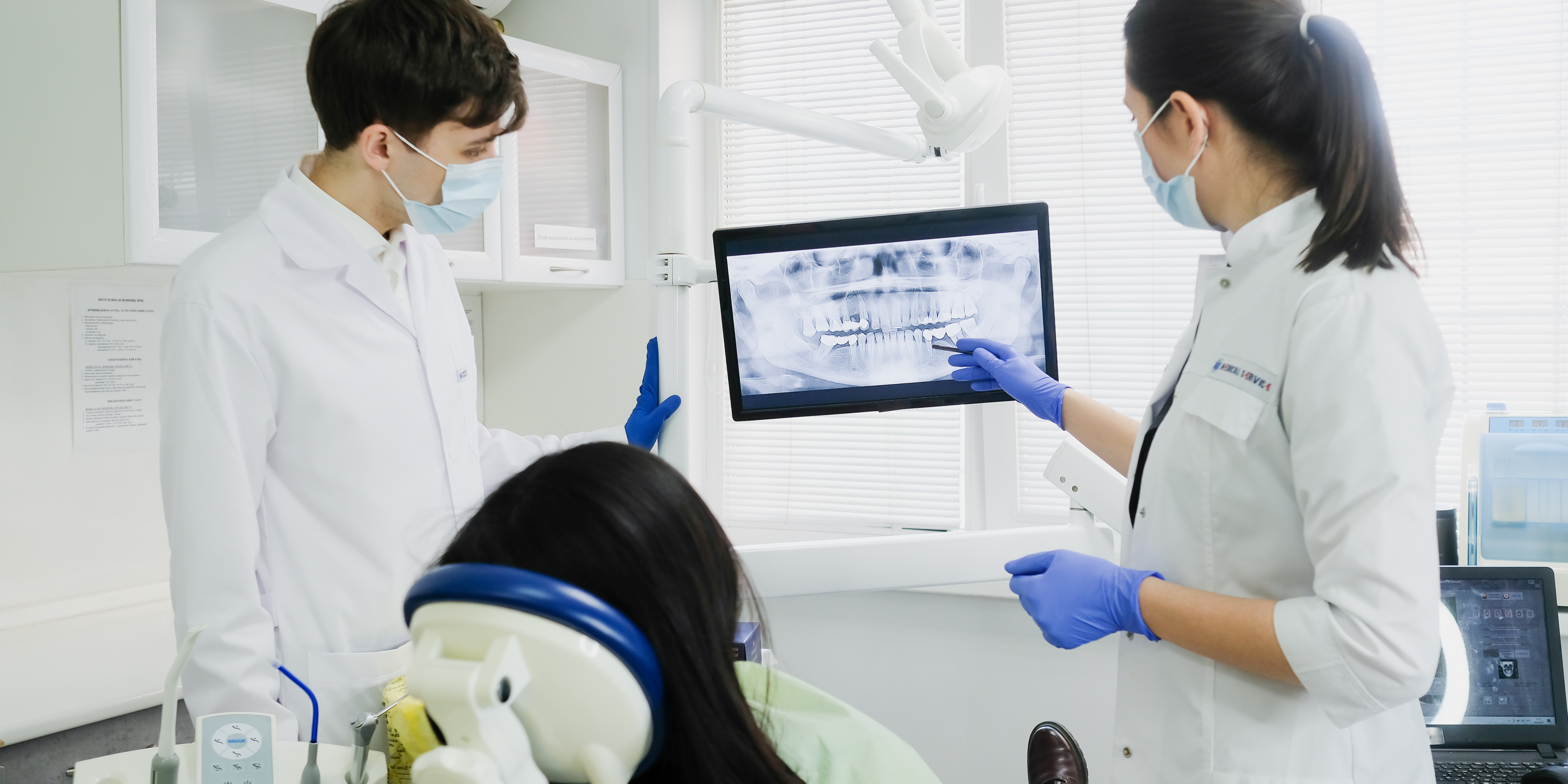 Dentist showing teeth xrays to patient 
